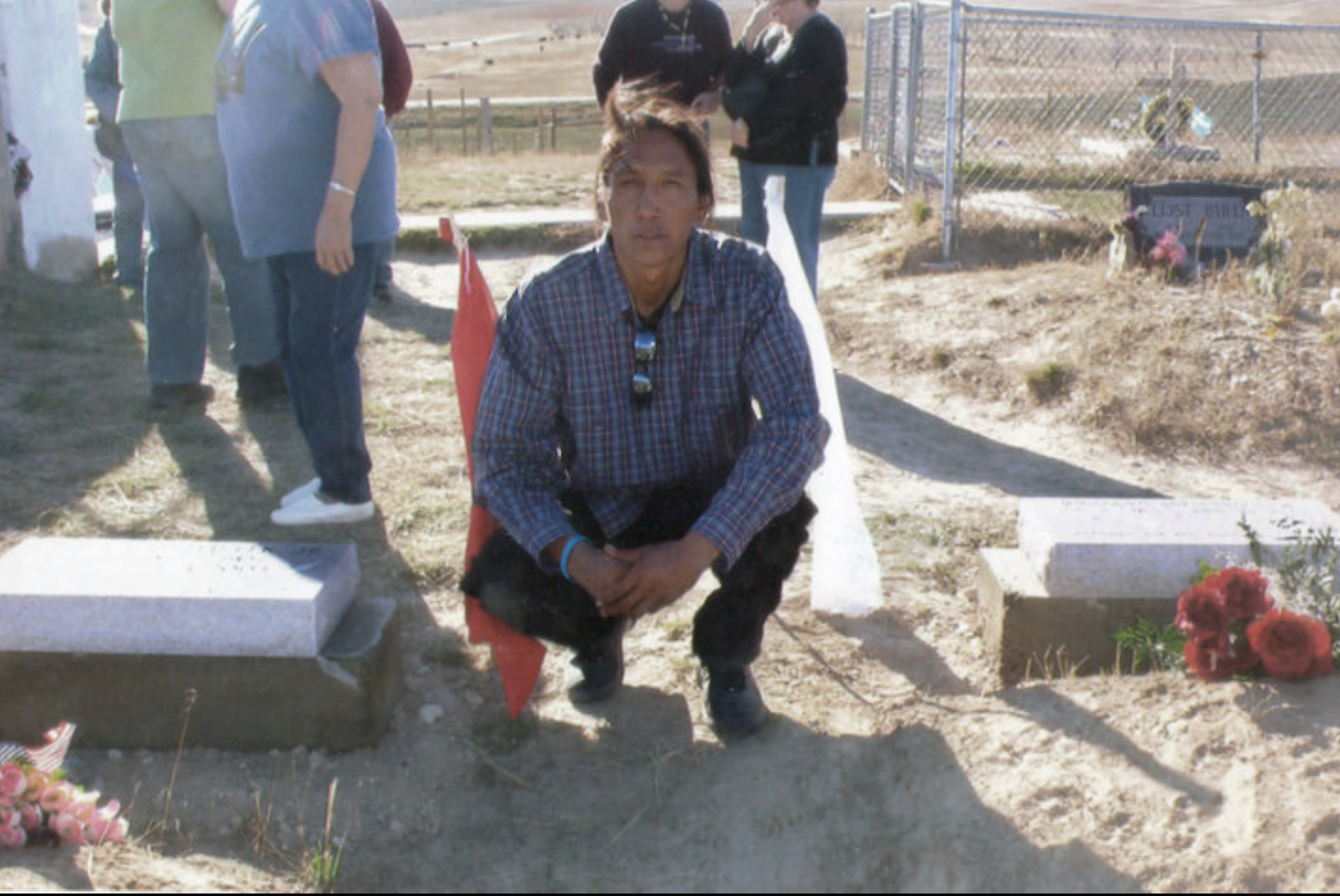 Calvin Spotted Elk putting headstones in for Jasper and Richard